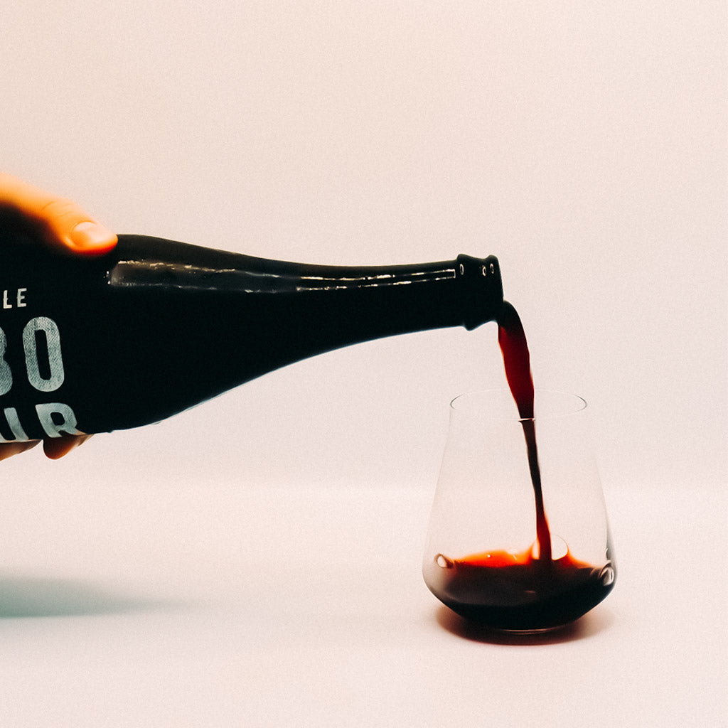 Luddite Saboteur Red Wine Bottle pouring into glass, Bot River, South Africa