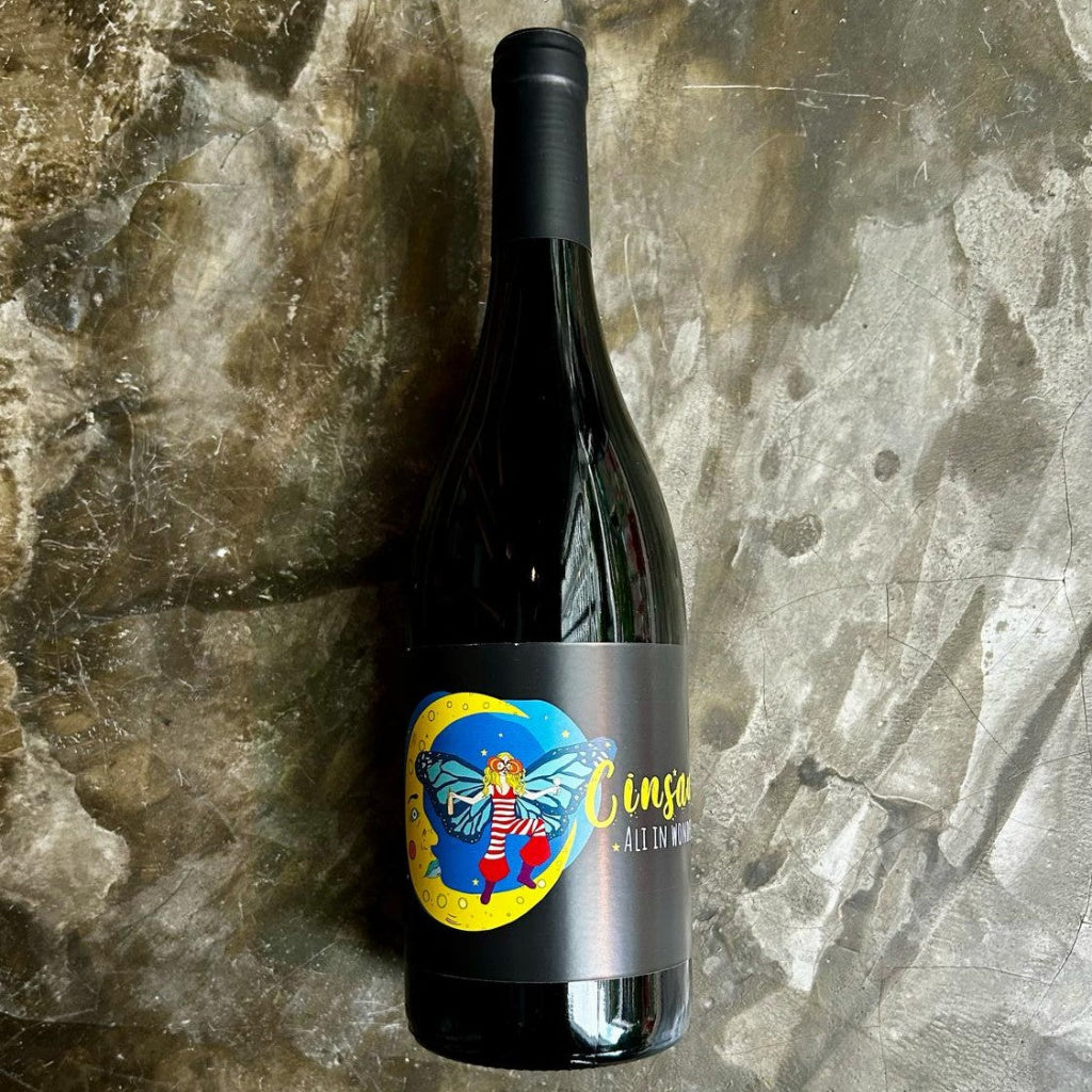 Bottle of Ali in Wonderfuland Cinsault on concrete floor