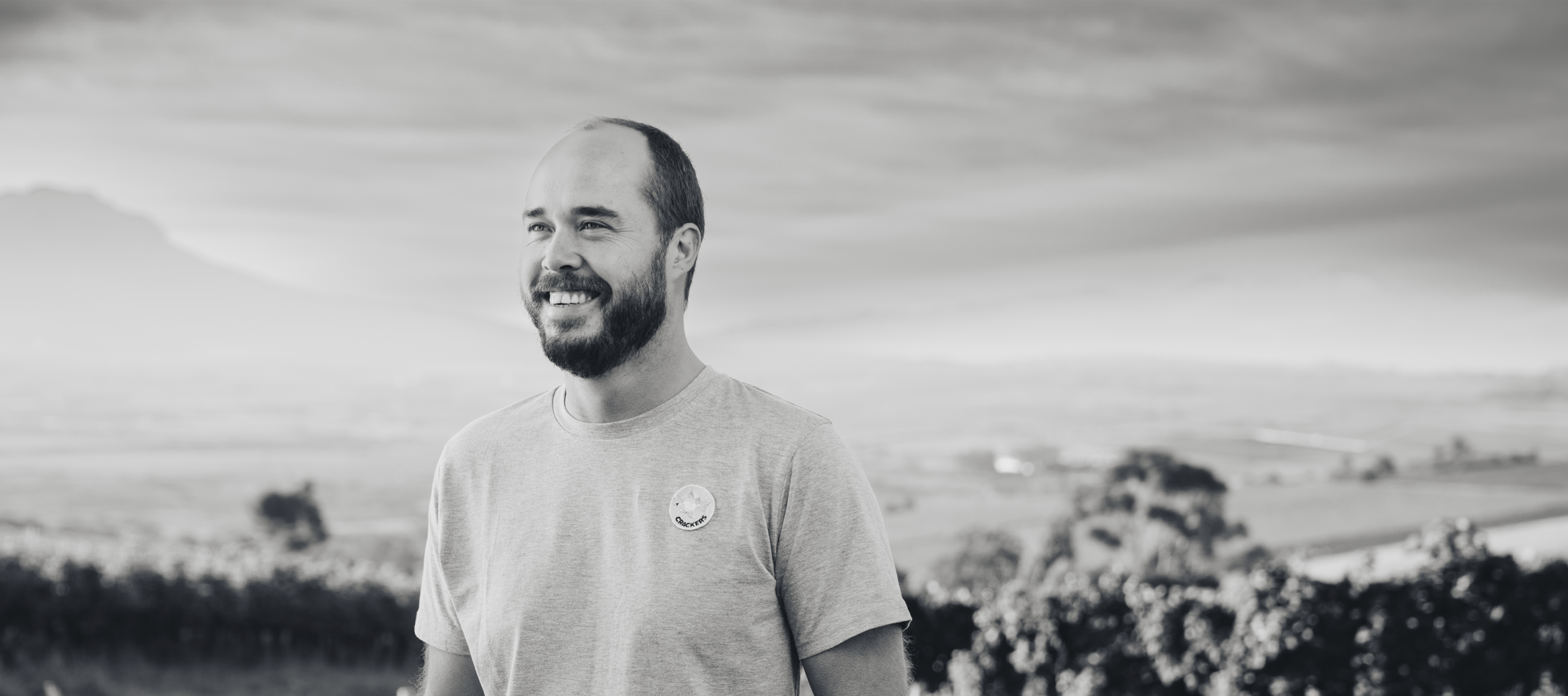 Reenen Borman standing in a vineyard with a scenic background