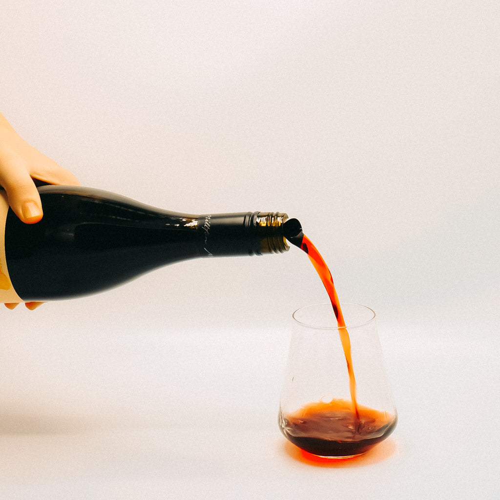 Millton Cosmo Red Wine Bottle Pouring into glass